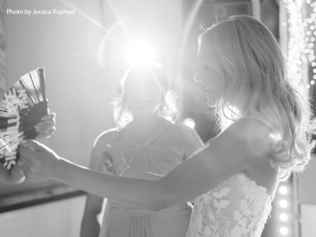 Keeping cool on the dance floor Bride with her fan to keep cool