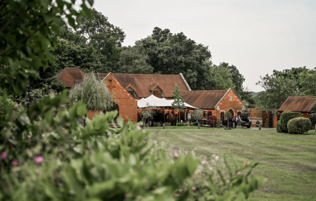 Beautiful garden view of the Stables barn at Nuthurst Grange