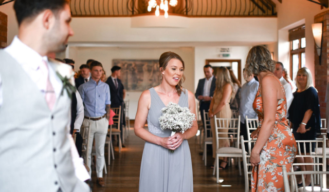 Bridesmaid smiling at Nuthurst Grange hotel
