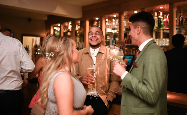 People having fun while enjoying a drink at the Stables bar